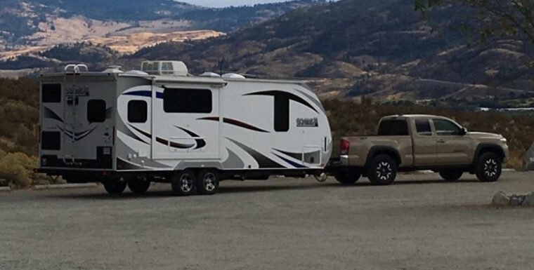 A toyota tacoma towing a travel trailer